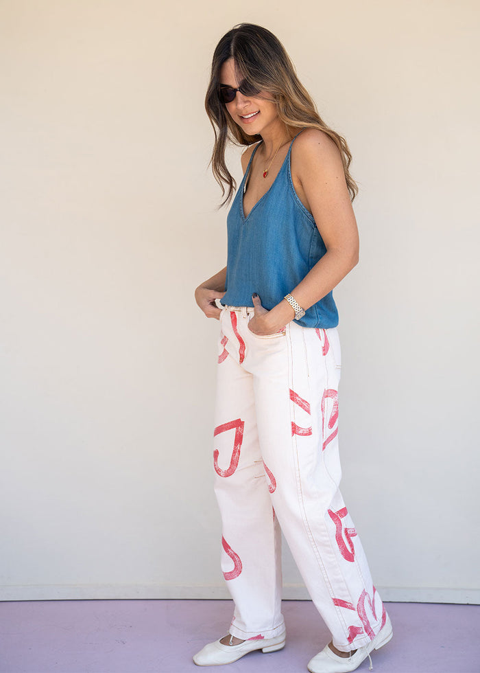 Ivory cotton drill jean with all-over red heart print, wide leg, side cuts, and knee darts, view 5