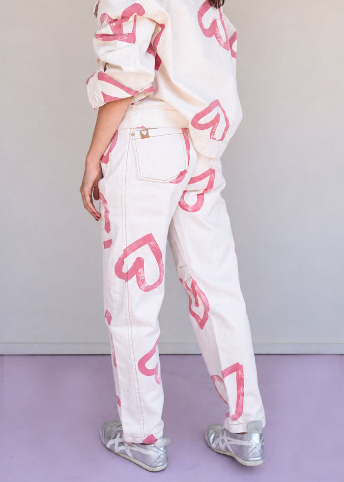 Ivory cotton drill jean with all-over red heart print, wide leg, side cuts, and knee darts, view 6