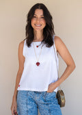 Ivory rayon-linen sleeveless blouse with round neckline and heart-shaped side buttons