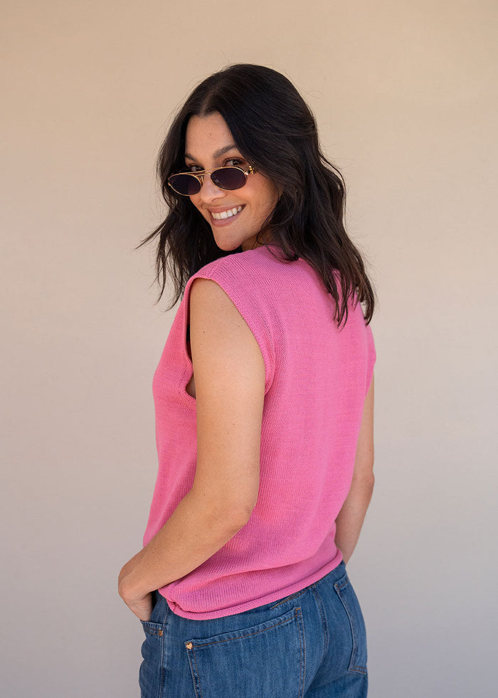 Pink acrylic knit vest with round neck and contrast green heart motif at the chest, view 7