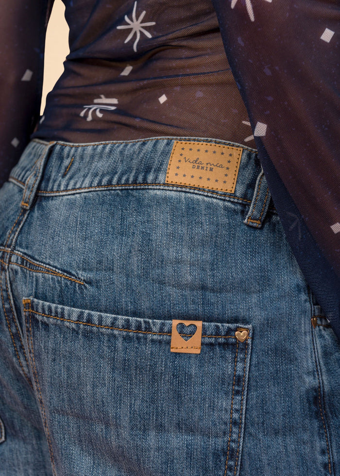 Rigid indigo denim jean with belted waistband, straight leg, and functional pockets, view 3